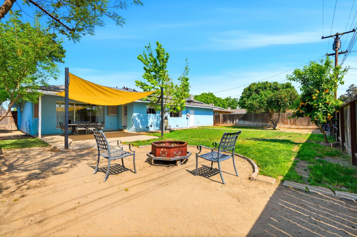 289 West Cypress Avenue Reedley, CA 93654 - Photo 37 of 45 a view of a patio with table and chairs potted plants and palm tree