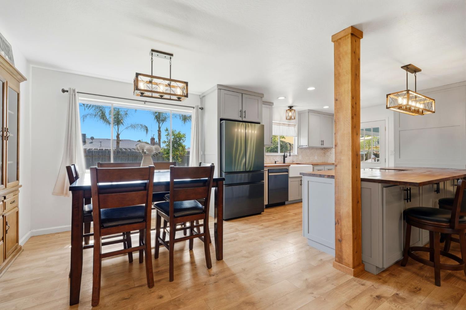 289 West Cypress Avenue Reedley, CA 93654 - Photo 5 of 45 a kitchen with kitchen island a dining table and appliances