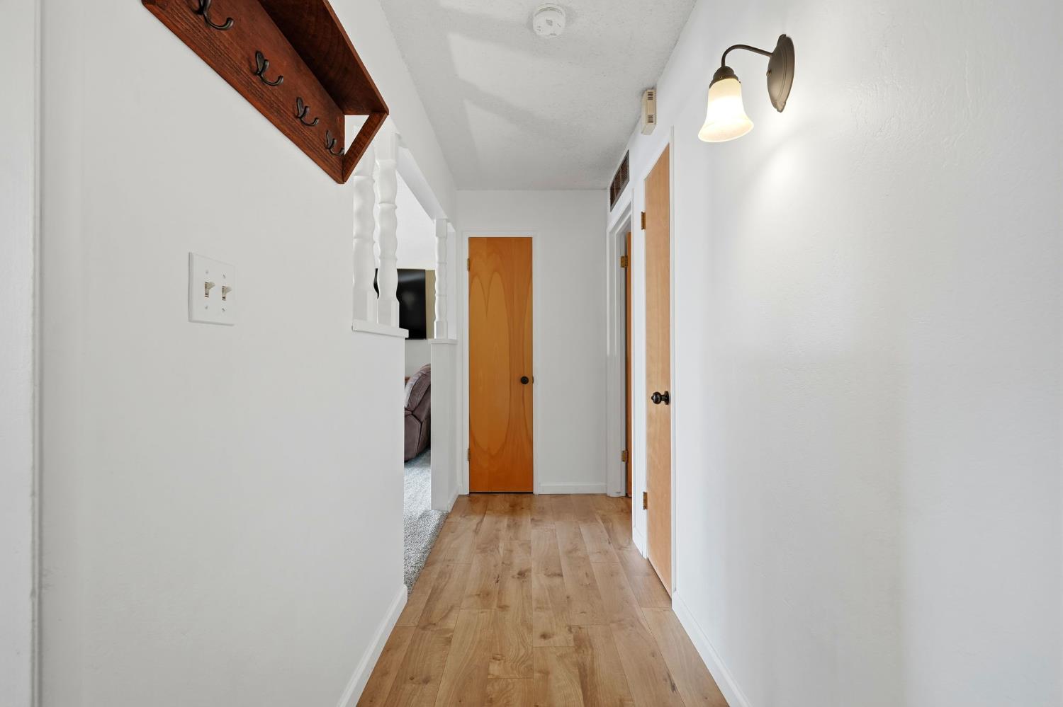 289 West Cypress Avenue Reedley, CA 93654 - Photo 8 of 45 a view of a hallway with wooden floor and staircase