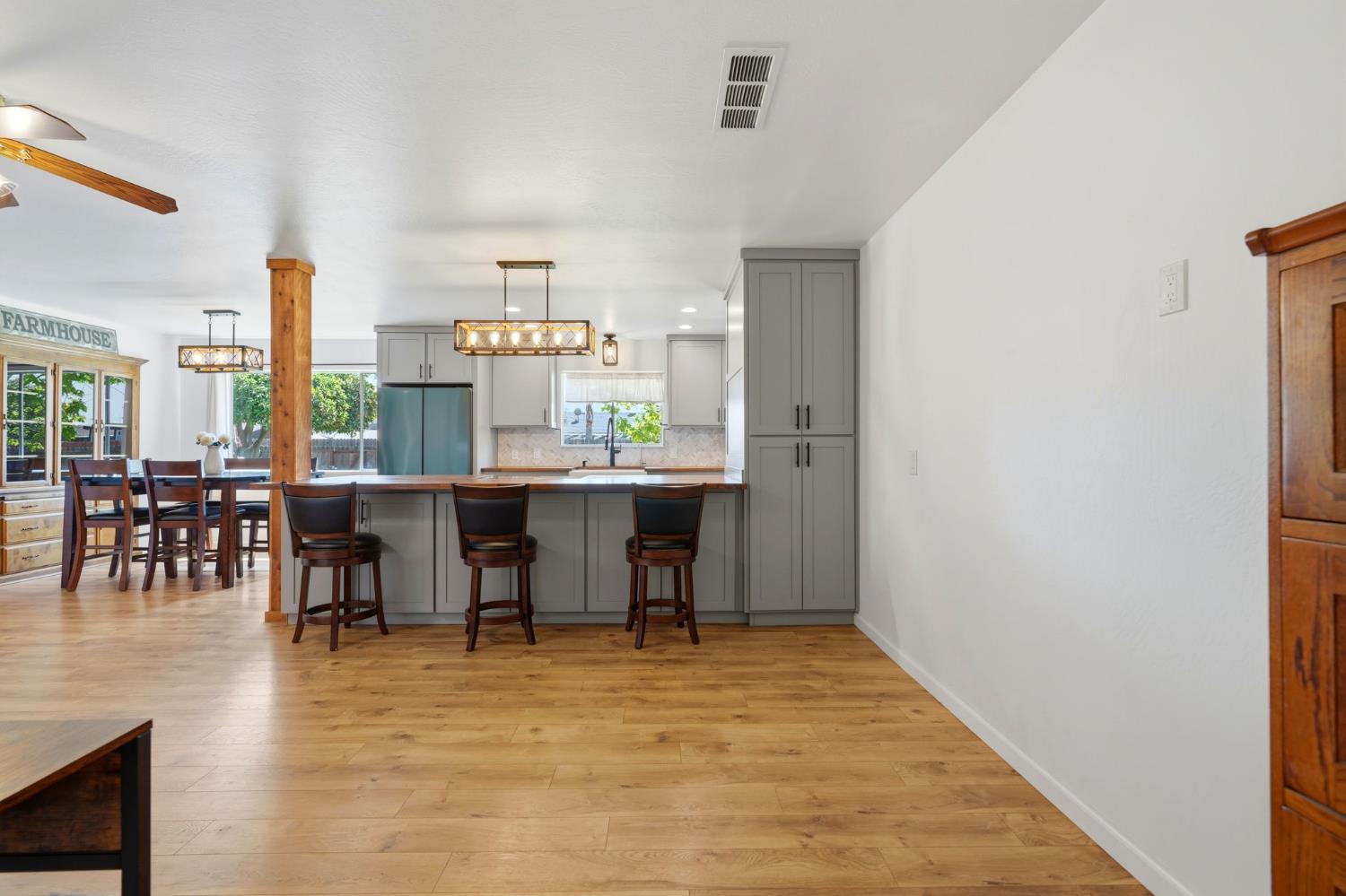 289 West Cypress Avenue Reedley, CA 93654 - Photo 10 of 45 a room with stainless steel appliances a dining table chairs and a refrigerator