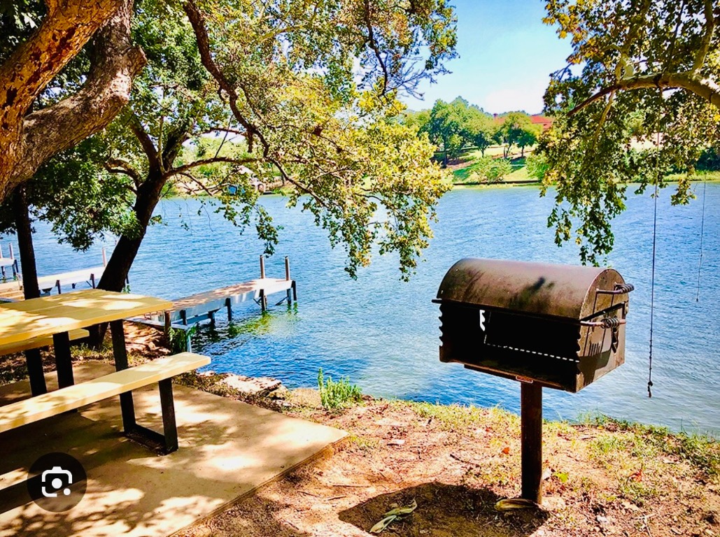 3120 Geronimo Trail Austin, TX 78734 - Photo 7 of 10 a backyard of a house with barbeque oven and a table and chairs