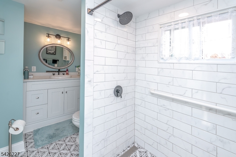 36 Main Street Flanders, NJ 07836 - Photo 27 of 49 a bathroom with a sink a toilet and mirror