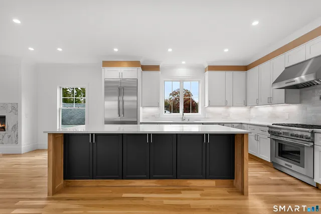 a kitchen with stainless steel appliances a sink and a stove