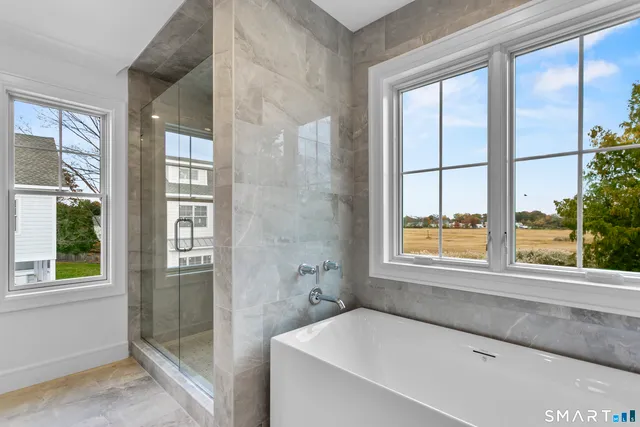 a bathroom with a bathtub and windows