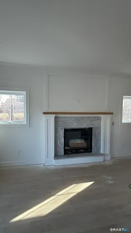 a view of empty room with a fireplace