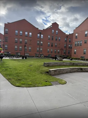 a big building with a big yard and plants