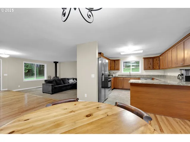 a kitchen with stainless steel appliances granite countertop a refrigerator and a sink