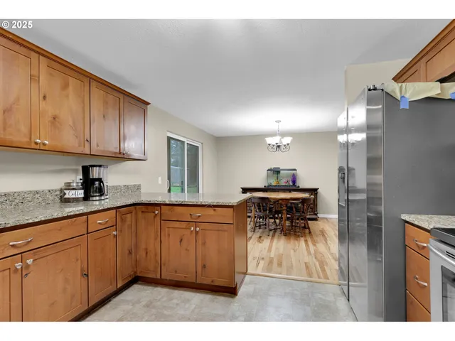 a kitchen with stainless steel appliances granite countertop a sink and cabinets