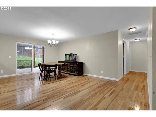 a view of a room with furniture and wooden floor