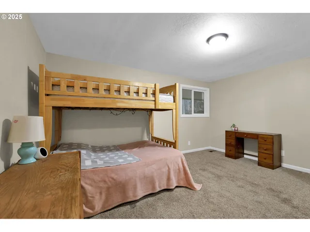 a bedroom with a bed and a television