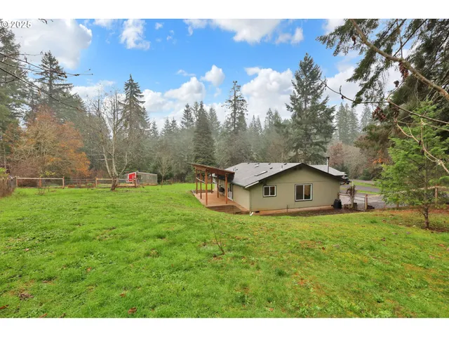 a view of a house with a yard and sitting area