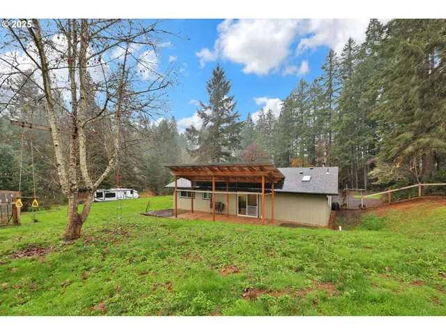 a backyard of a house with table and chairs