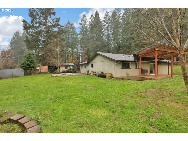 a view of a house with a yard and sitting area