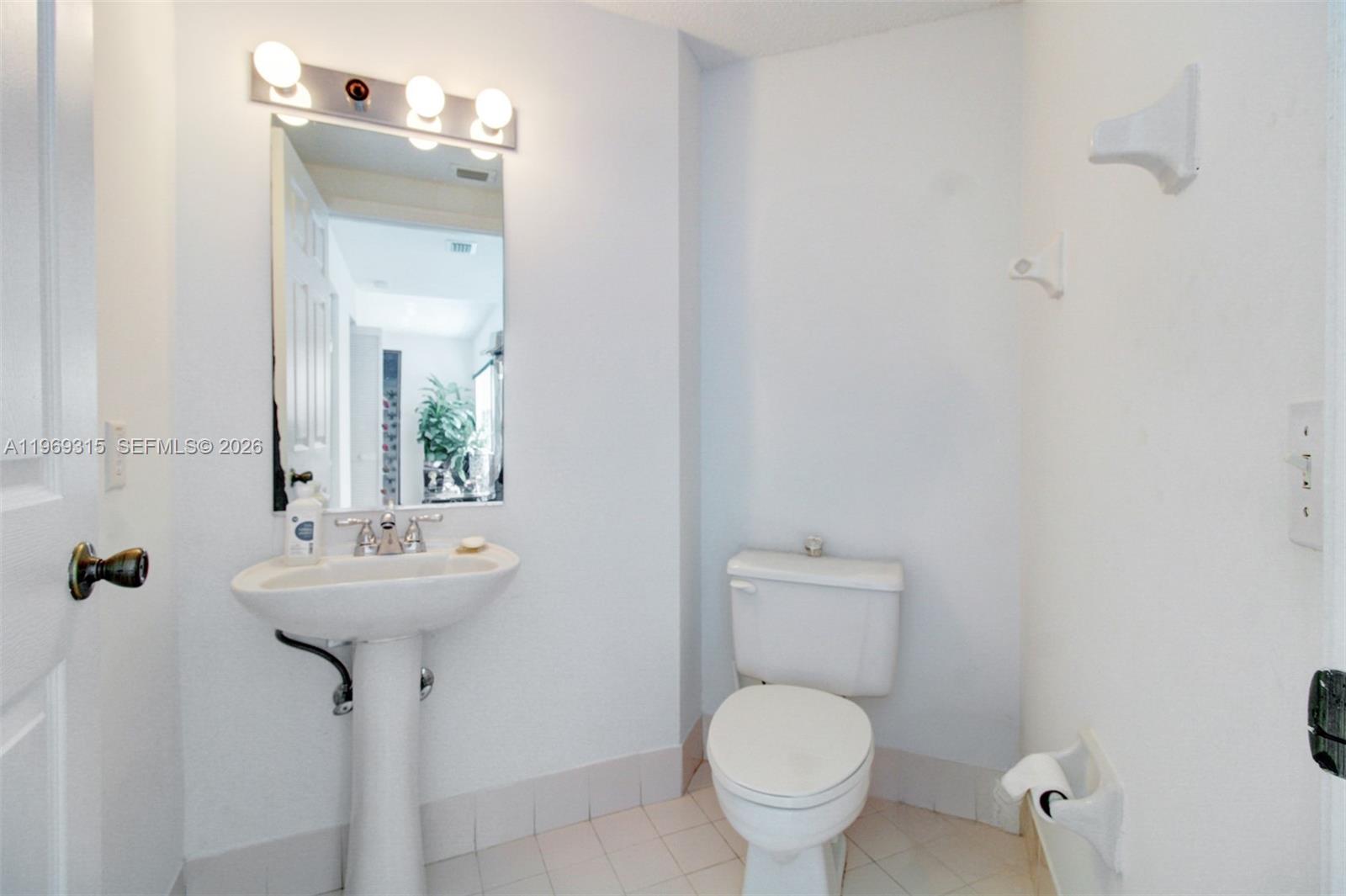 15490 Southwest 47th Street Miami, FL 33185 - Photo 12 of 43 a bathroom with a toilet sink and mirror