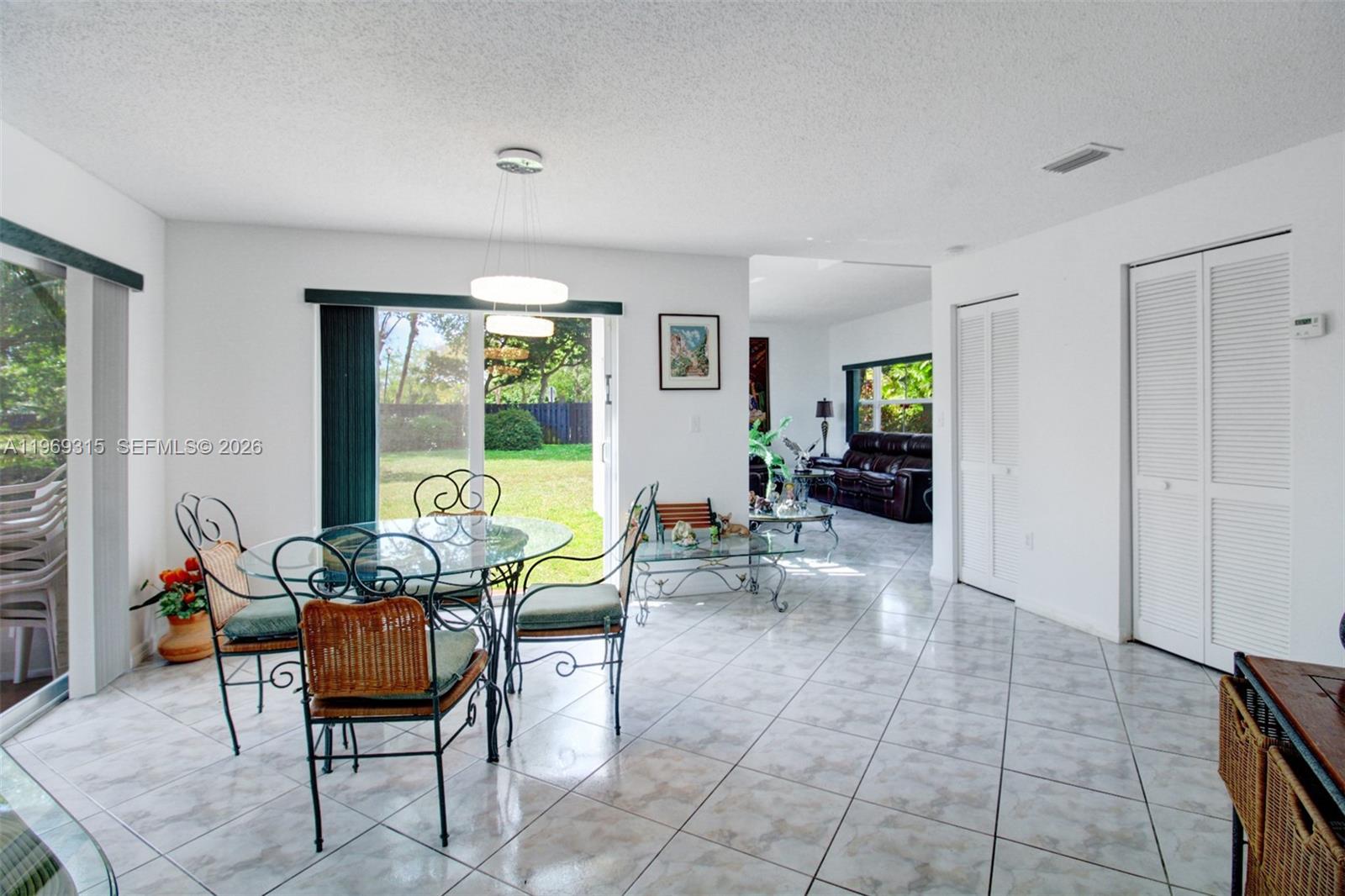 15490 Southwest 47th Street Miami, FL 33185 - Photo 13 of 43 a living room with furniture and a large window