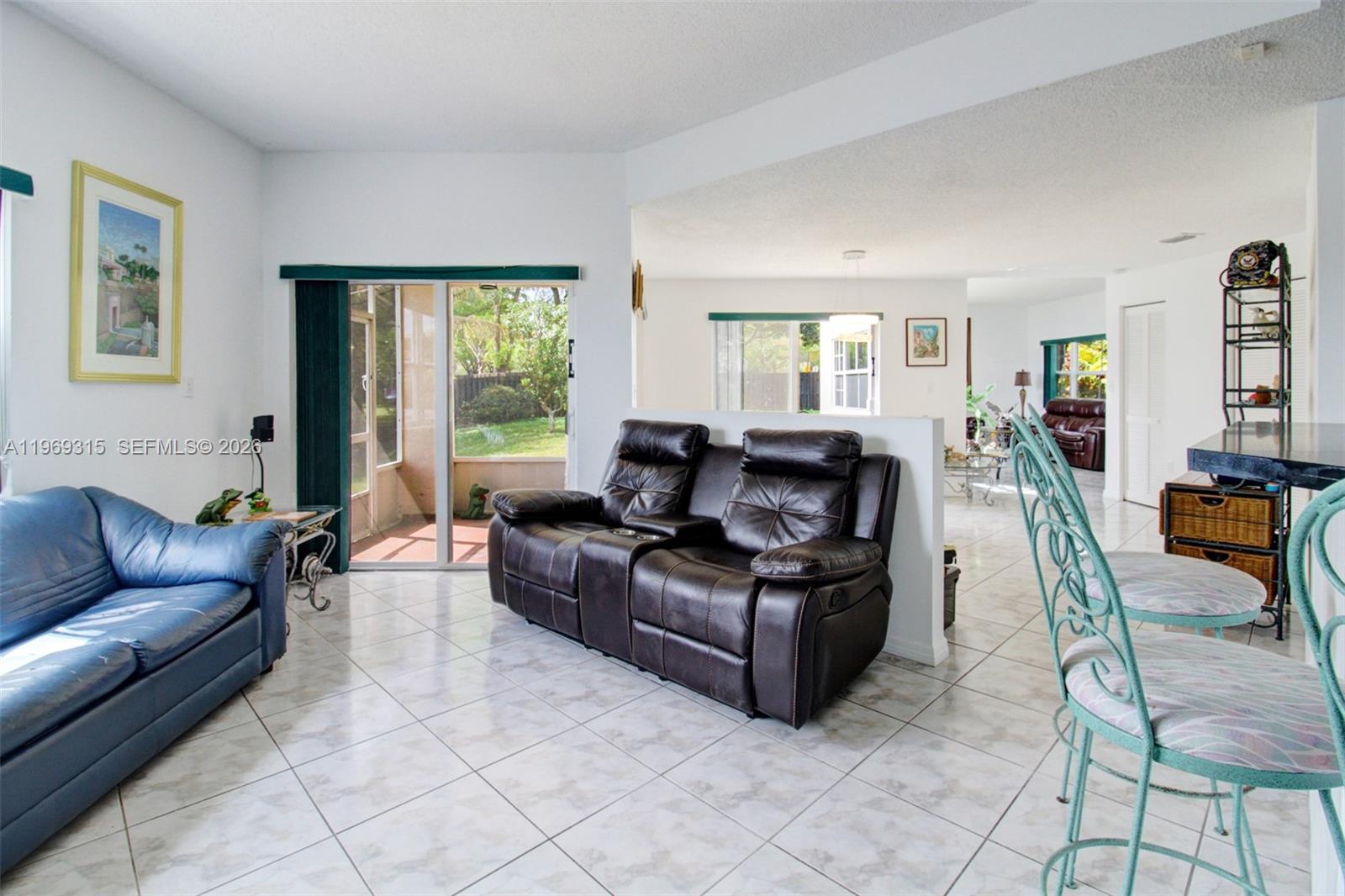 15490 Southwest 47th Street Miami, FL 33185 - Photo 15 of 43 a living room with furniture and a window