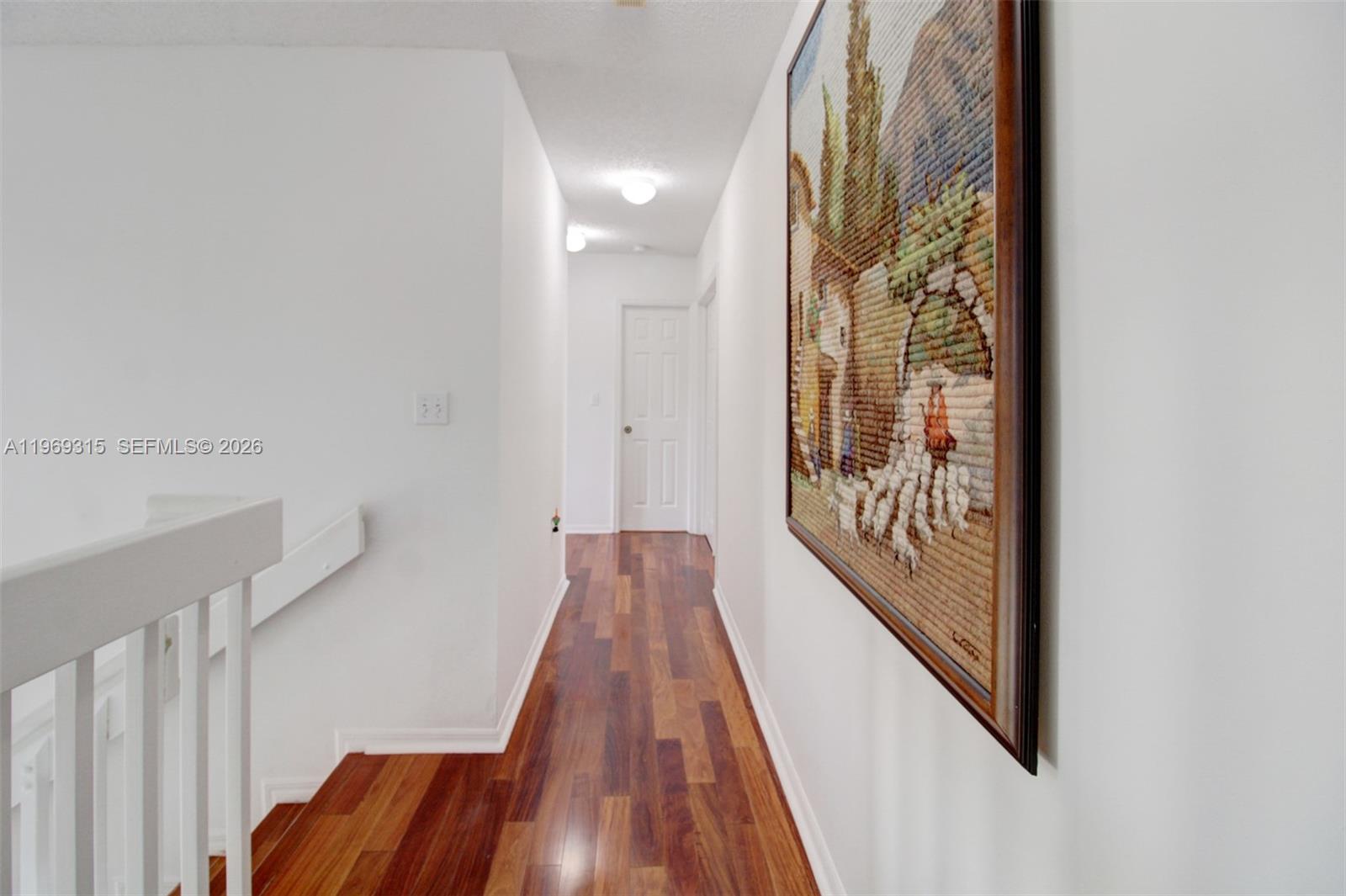 15490 Southwest 47th Street Miami, FL 33185 - Photo 22 of 43 a view of a hallway with wooden floor and stairs