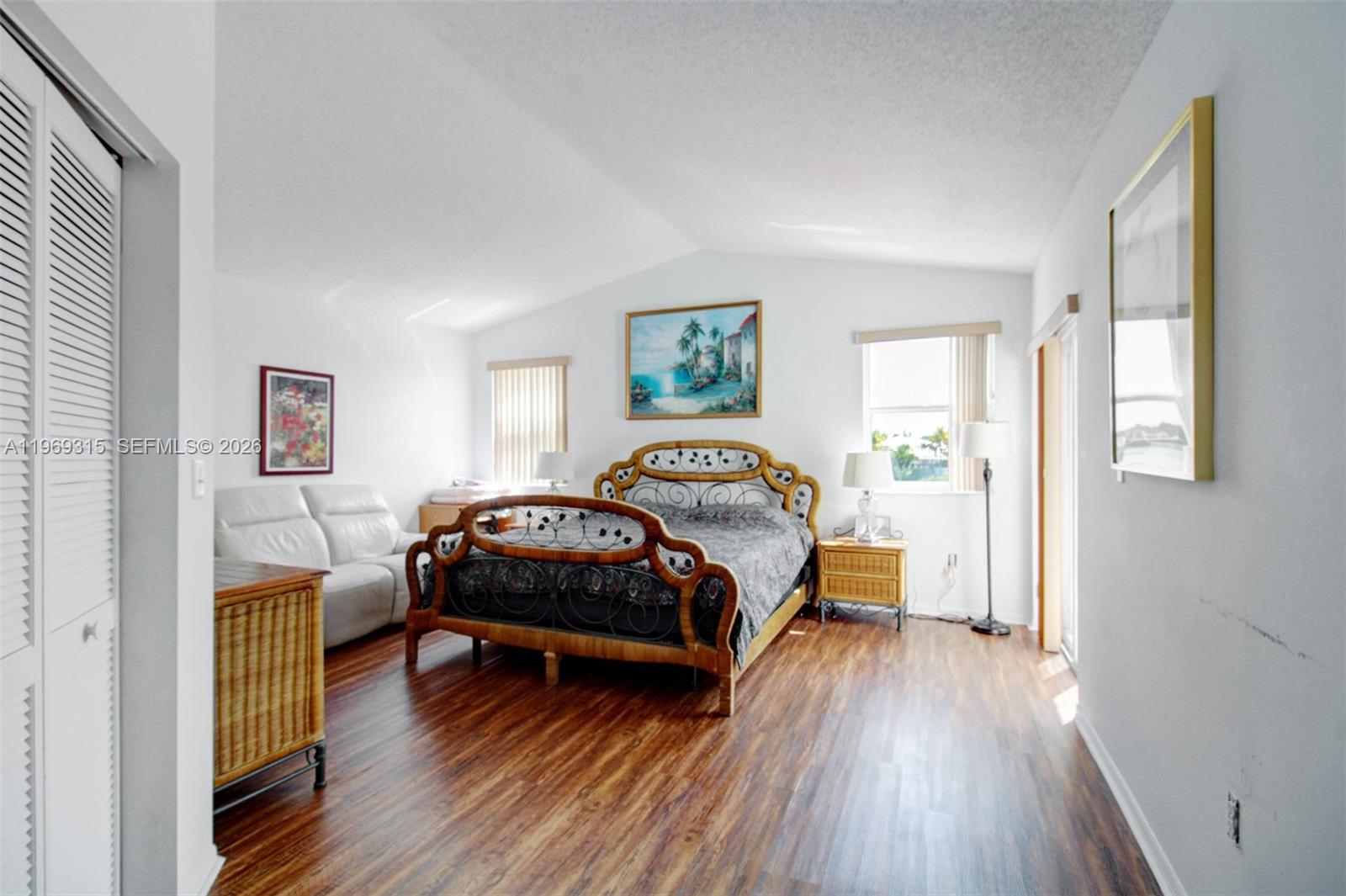 15490 Southwest 47th Street Miami, FL 33185 - Photo 26 of 43 a bedroom with a bed and a wooden floor