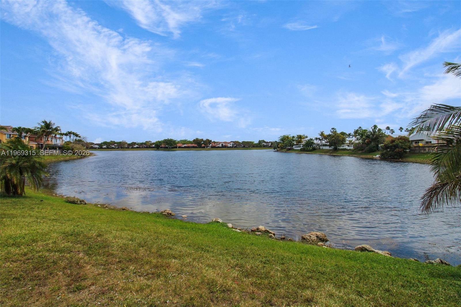 15490 Southwest 47th Street Miami, FL 33185 - Photo 36 of 43 a view of a lake with houses in the background