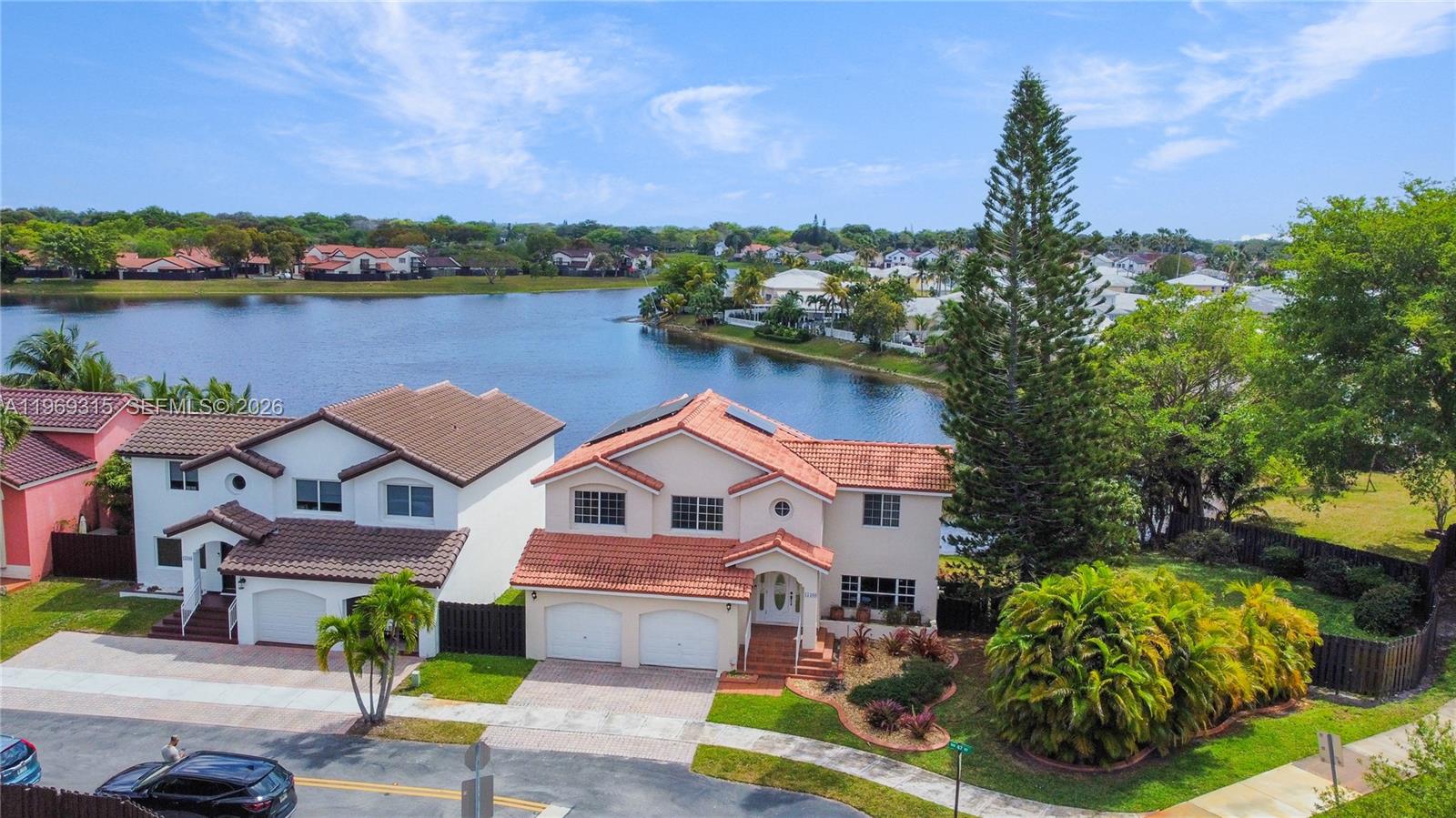 15490 Southwest 47th Street Miami, FL 33185 - Photo 42 of 43 a aerial view of a house with outdoor space and lake view in back