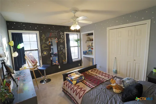 a bedroom with bed and wooden floor