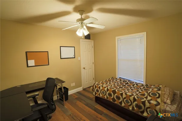 a bedroom with a bed and a table