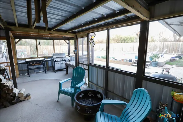 a living room with furniture tv and a large window