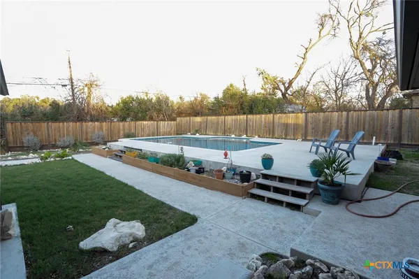 a backyard of a house with yard and outdoor seating