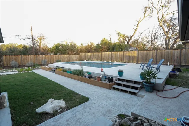 a backyard of a house with yard and outdoor seating