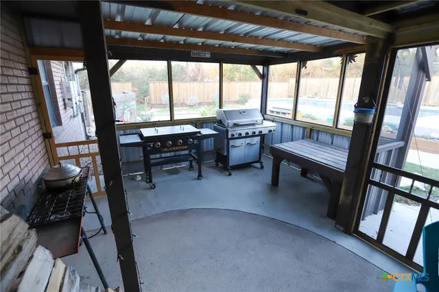 a dining room with furniture and a floor to ceiling window