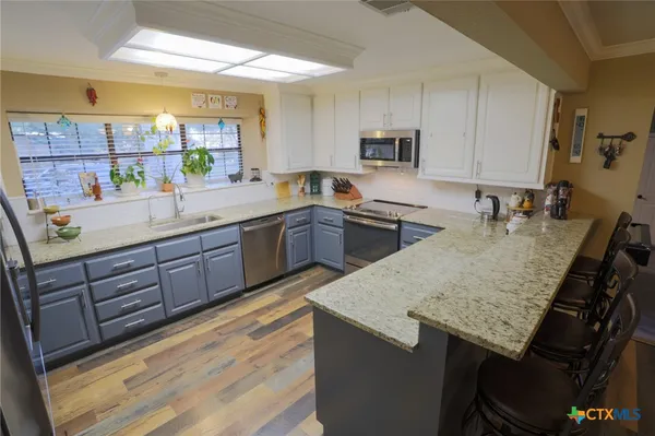 a kitchen with a sink and cabinets