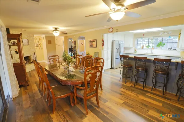 a view of a dining room with furniture and wooden floor