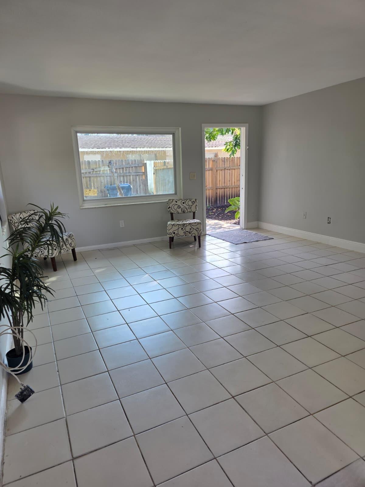 3386 Rudolph Road Lake Worth Beach, FL 33461 - Photo 6 of 25 an empty room with windows and fan