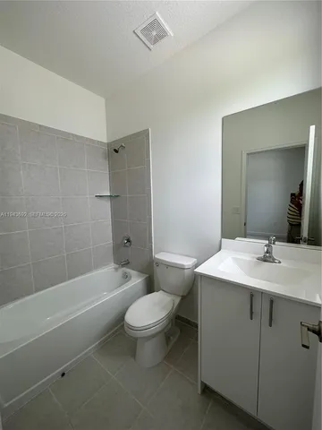 a view of a livingroom with furniture and a kitchen