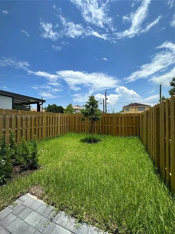 a kitchen with kitchen island a sink a stove and cabinets