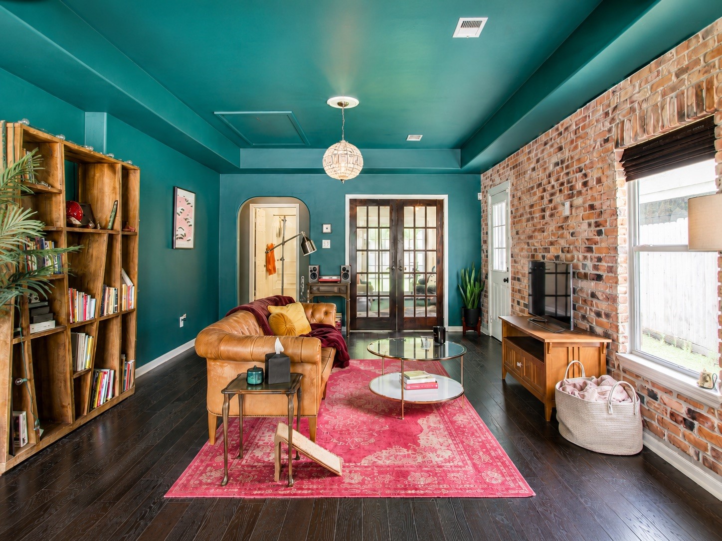 Inside a brick accent wall sets a bold living-room scene. (photo has been enhanced for marketing purposes)