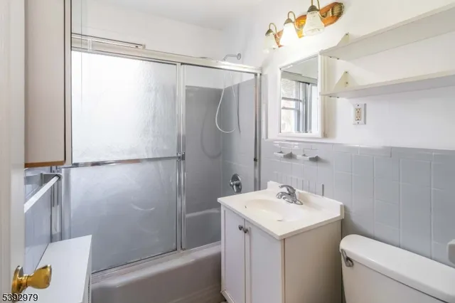 a bathroom with a sink a mirror and a shower