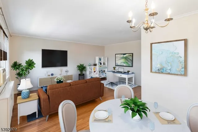 a living room with furniture a chandelier and a flat screen tv