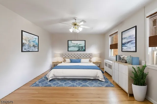 a spacious bedroom with a bed and a chandelier