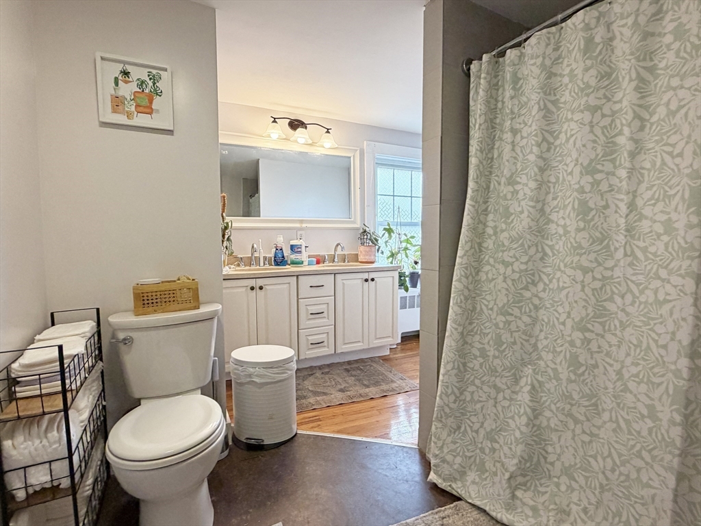 75-77 Dale Street, Unit 77 Waltham, MA 02451 - Photo 16 of 17 a bathroom with a sink toilet and a mirror
