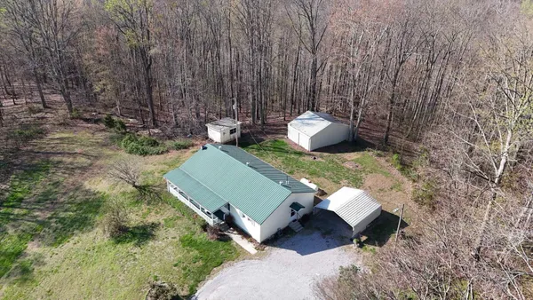 an aerial view of a house with a yard