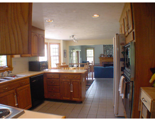 16 Newcombs Mill Road Kingston, MA 02364 - Photo 2 of 6 a large kitchen with stainless steel appliances granite countertop a large counter top a sink a stove and a refrigerator