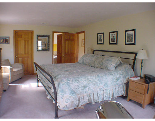 16 Newcombs Mill Road Kingston, MA 02364 - Photo 4 of 6 a bedroom with a bed and wooden floor