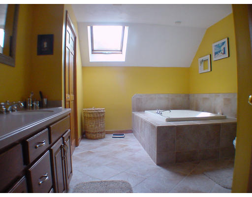 16 Newcombs Mill Road Kingston, MA 02364 - Photo 5 of 6 a bathroom with a tub sink and mirror