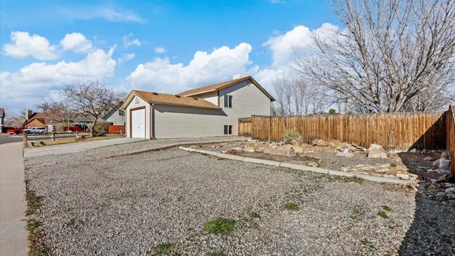 a view of a house with a yard covered in the road