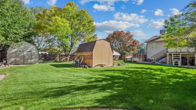 a view of a backyard with large trees