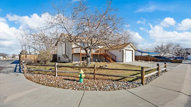 a view of a house with a yard and covered with snow