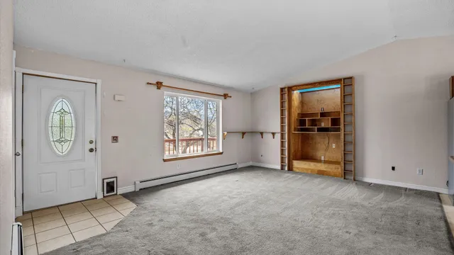 an empty room with windows and closet