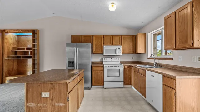 a kitchen with a stove sink and refrigerator
