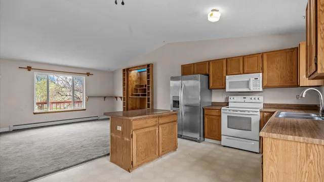 a kitchen with a stove top oven sink and refrigerator